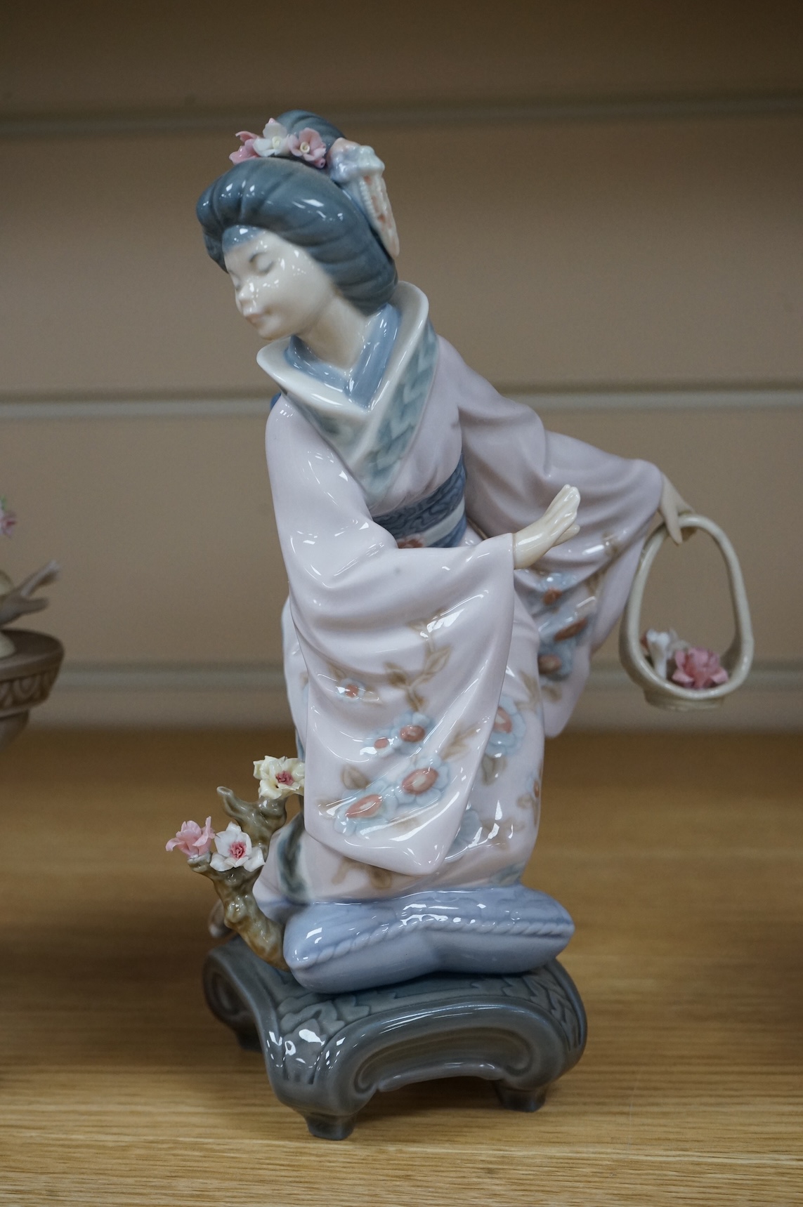 Three Lladro models of seated Geisha. Tallest 23cm